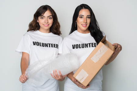 Two women who are volunteering to help a causeの写真素材