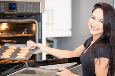Woman baking cookies for her family in the kitchenの写真素材