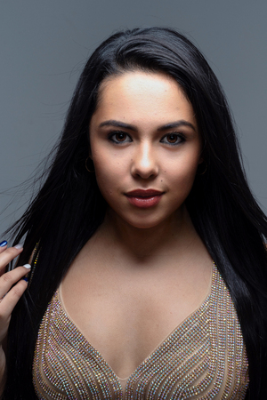 Young teenage hispanic fashion model posing in a studioの写真素材