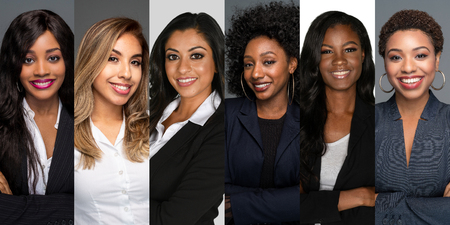 Group of six happy minority businesswomen at work