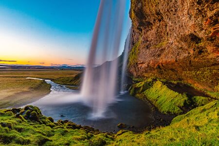 Sunset view of Seljalandsfoss waterfall in Iceland during the summer