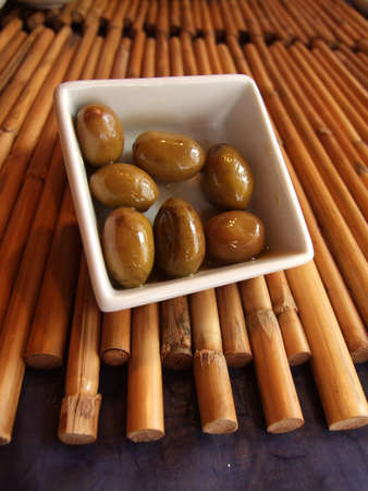 Olives in a bowl on the bambooの写真素材