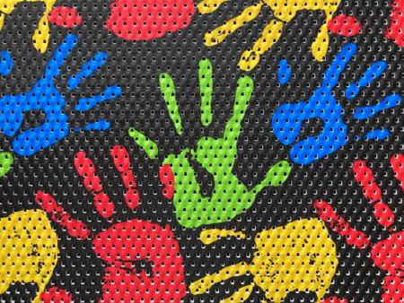 Colorful hand prints on a black metal background. Closeup.の写真素材