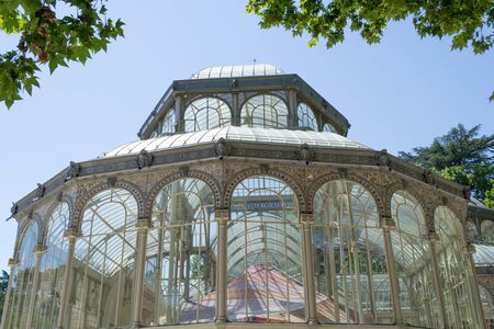 The Crystal Palace is located in the heart of the buen retiro park in Madrid in front of a lakeのeditorial素材