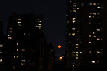 Red moon from a rooftop terrace in the Upper East Side of NYCの写真素材
