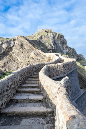 Bridge and stairway containing 241 stairs to climb to San Juan de Gaztelugatxeの写真素材