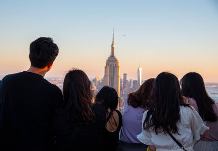 Tourists looking at the Empire State one of the most iconic buildings in NYCの写真素材