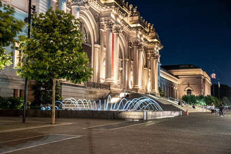 Facade and fountain of the Metropolitan museum of art at night in NYCのeditorial素材