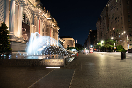 Facade and fountain of the Metropolitan museum of art at night in NYCのeditorial素材