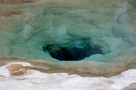 blue and white hot spring in yellowstone national park