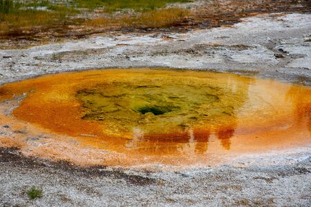 Orange hot spring in Yellowstone of vivid colors caused by thermophilic bacteriaの写真素材