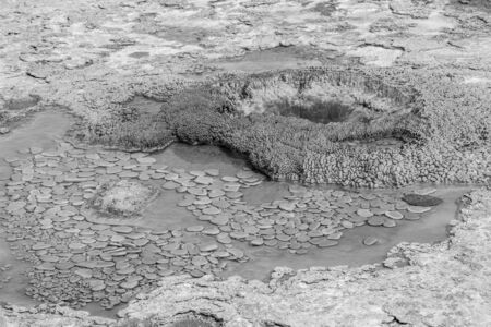 Small geyser before an eruption in the upper geyser basin in Yellowstone, in black and whiteの写真素材