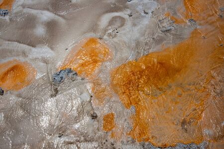 Orange and grey smear coming from a hot spring in Yellowstone National Parkの写真素材