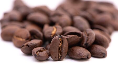 Macro photograph of coffee beans isolated over a white backgroundの写真素材