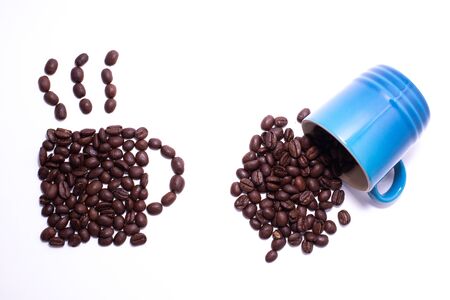 Cup of coffee shape created with coffee beans and a cup of spilled coffee beans over a white backgroundの写真素材