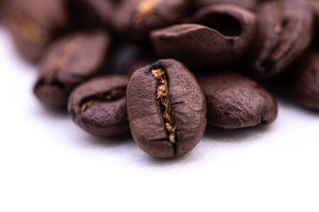 Macro photograph of coffee beans isolated over a white backgroundの写真素材