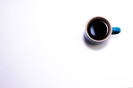 Blue porcelain cup filled with coffeeの写真素材