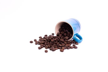 Coffee beans spilled from a mug isolated over a white backgroundの写真素材