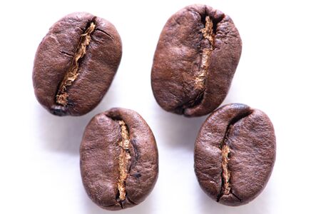 Macro photograph of coffee beans isolated over a white backgroundの写真素材