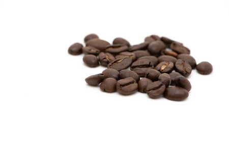 Macro photograph of coffee beans isolated over a white backgroundの写真素材