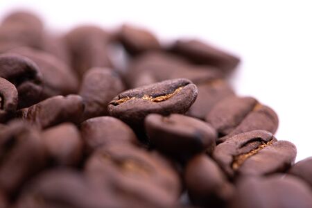 Macro photograph of coffee beans isolated over a white backgroundの写真素材