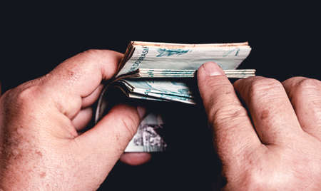 Real, Brazilian currency. Money, Brazil, Hand. A woman holding a group of brazilian banknotes.の写真素材