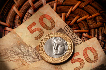 Real, Brazilian currency. Money, Brazil. A brazilian coin and brazilian banknotes in close-up.