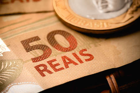 Real, Brazilian currency. Money, Brazil. A brazilian coin and brazilian banknotes in close-up.