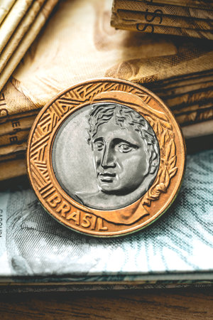 Real (BRL) - Money from Brazil. Money, Reais, Brazilian Real, Brazil. One Real coin in close up on a brazilian banknotes.の写真素材