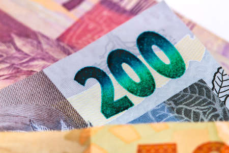 Money, Brazil, Money, Real, Reais. Real currency, money from Brazil. Brazilian banknotes and coins on a white surface. Banknotes of 200 reais and 50 reais.の写真素材