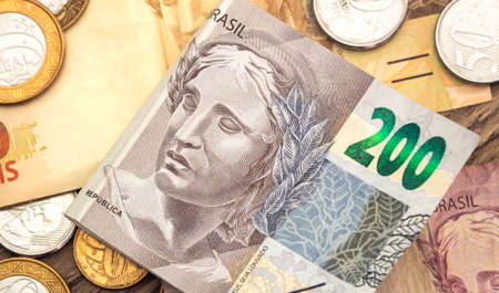 Money, Brazil, Money, Real, Reais. Real currency, money from Brazil. Brazilian banknotes and coins on a white surface. Banknotes of 200 reais and 50 reais.の写真素材
