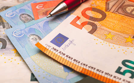 Euro banknotes and a pen close-up. High quality photoの写真素材