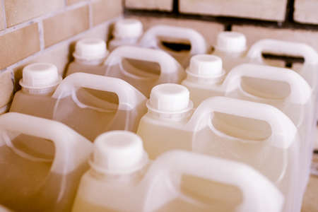 Plastic bottles of laundry detergent or bleach for washing dishes.の写真素材