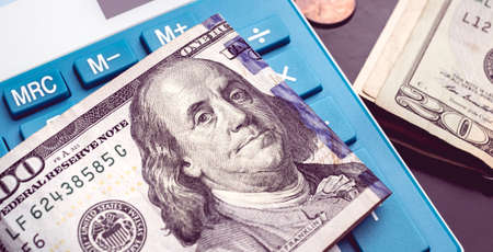 Calculator, dollars and coins. Business and finance concept.