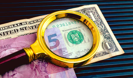 Close-up of a magnifying glass on a dollar bill.の写真素材