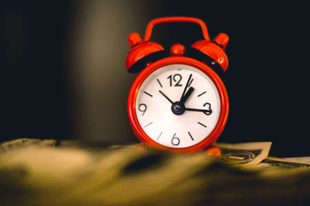 Alarm clock and money. Time is money. Time is money.の写真素材