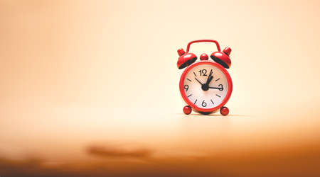 Retro alarm clock on orange background. Time concept. 3D Renderingの写真素材