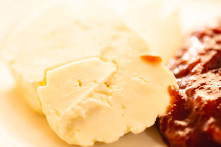 Close up of cheese with tomato sauce on white plate. Selective focus.の写真素材