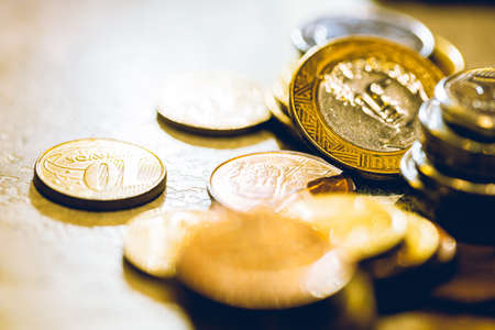 Coins of different countries on a wooden background. Selective focus.の写真素材