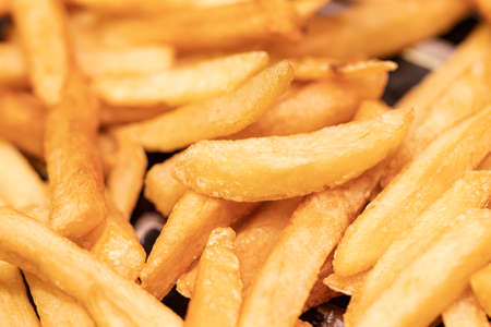 Golden French fries potatoes ready to be eaten at a fast food restaurant.