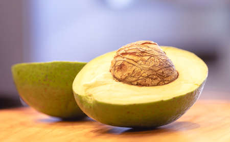 Avocado on a cutting board in the kitchen. Selective focus.の写真素材