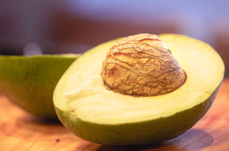 Avocado cut in half on a cutting board. Selective focus.