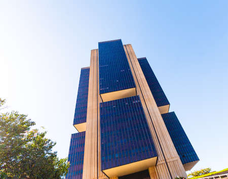 Modern office building with solar panels against blue sky. High quality photo