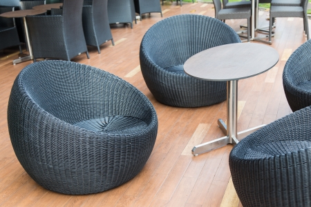 Wicker chairs and table  with view on wooden decking in Thailandの写真素材