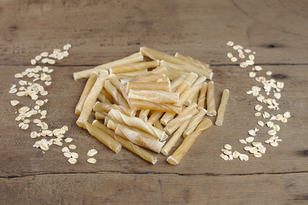 Dog bone on wooden background. it is snack for dogの写真素材
