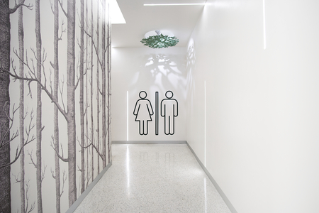 Toilets icon. Public restroom signs with female and male symbol. Interior of shopping mall.