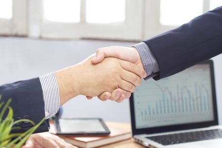 businessman shake hand at the office in the morningの写真素材