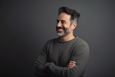 Portrait of a smiling man on a gray background in the studioの素材
