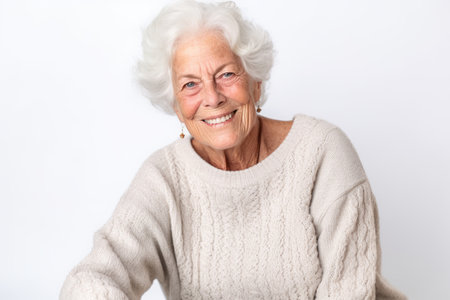 Portrait of a happy senior woman looking at camera on white backgroundの素材