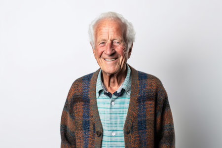 Portrait of a happy senior man smiling at the camera on a white backgroundの素材